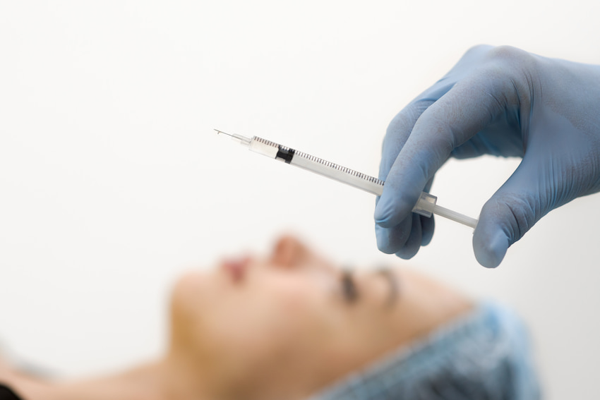 A nurse preparing needle for Botox injection
