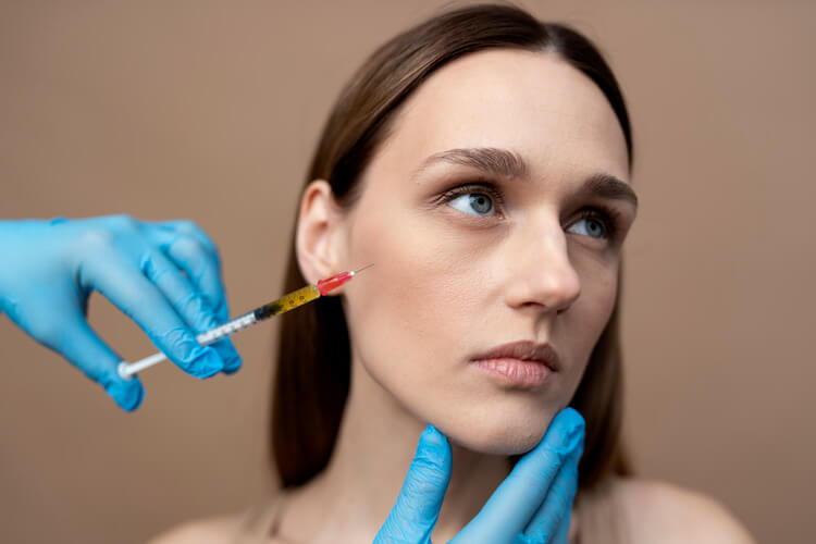 Young woman getting Botox injection